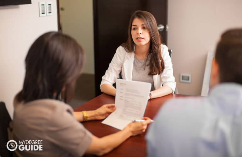 master's degree graduate having an interview in an office