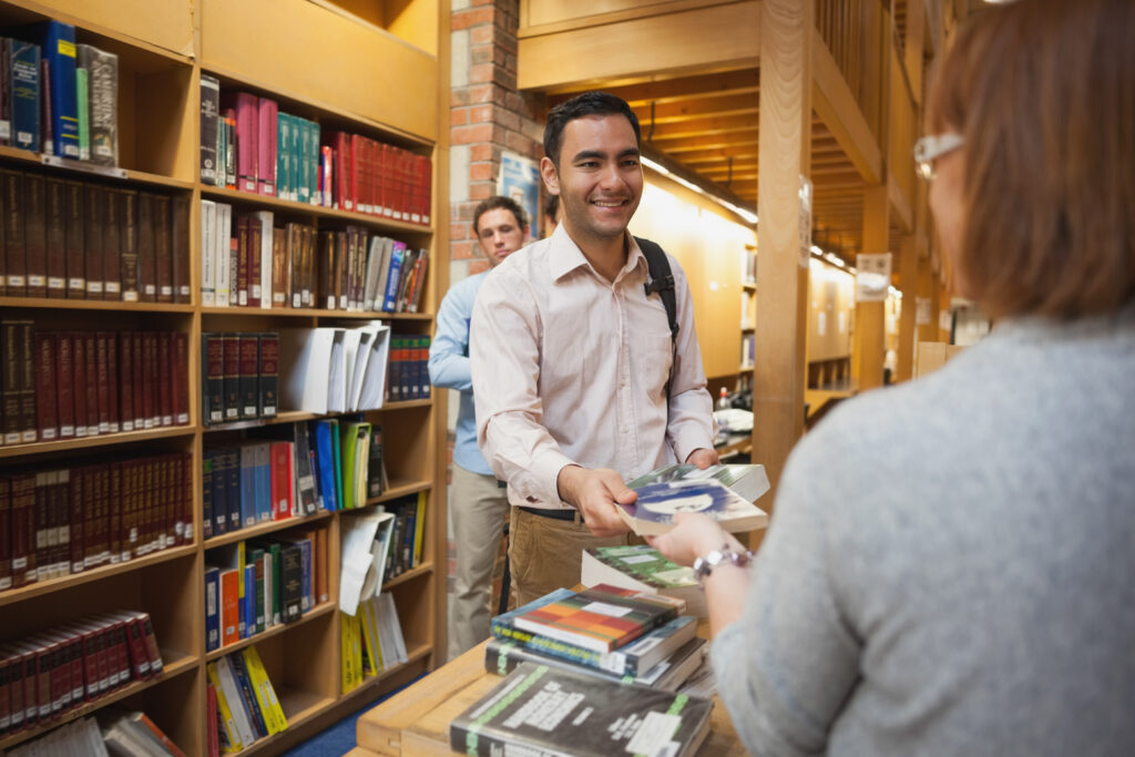 photo-young-man-checks-out-library-books-to-learn-dutch-free