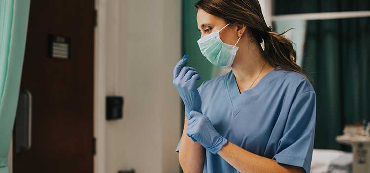 nurse pulling on latex glove